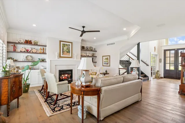 a spacious bedroom with a bed and a chandelier
