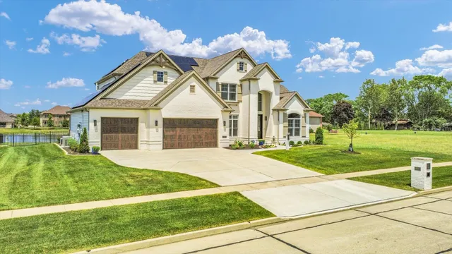 an aerial view of a house with swimming pool and garden