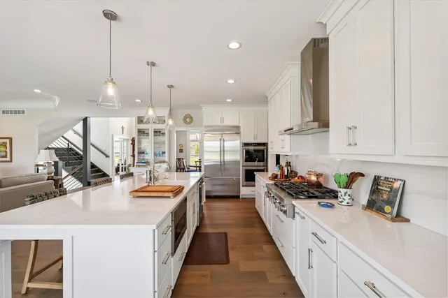 a view of staircase with wooden floor and a chandelier