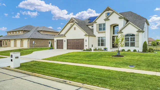 a living room with furniture a fireplace and a large window