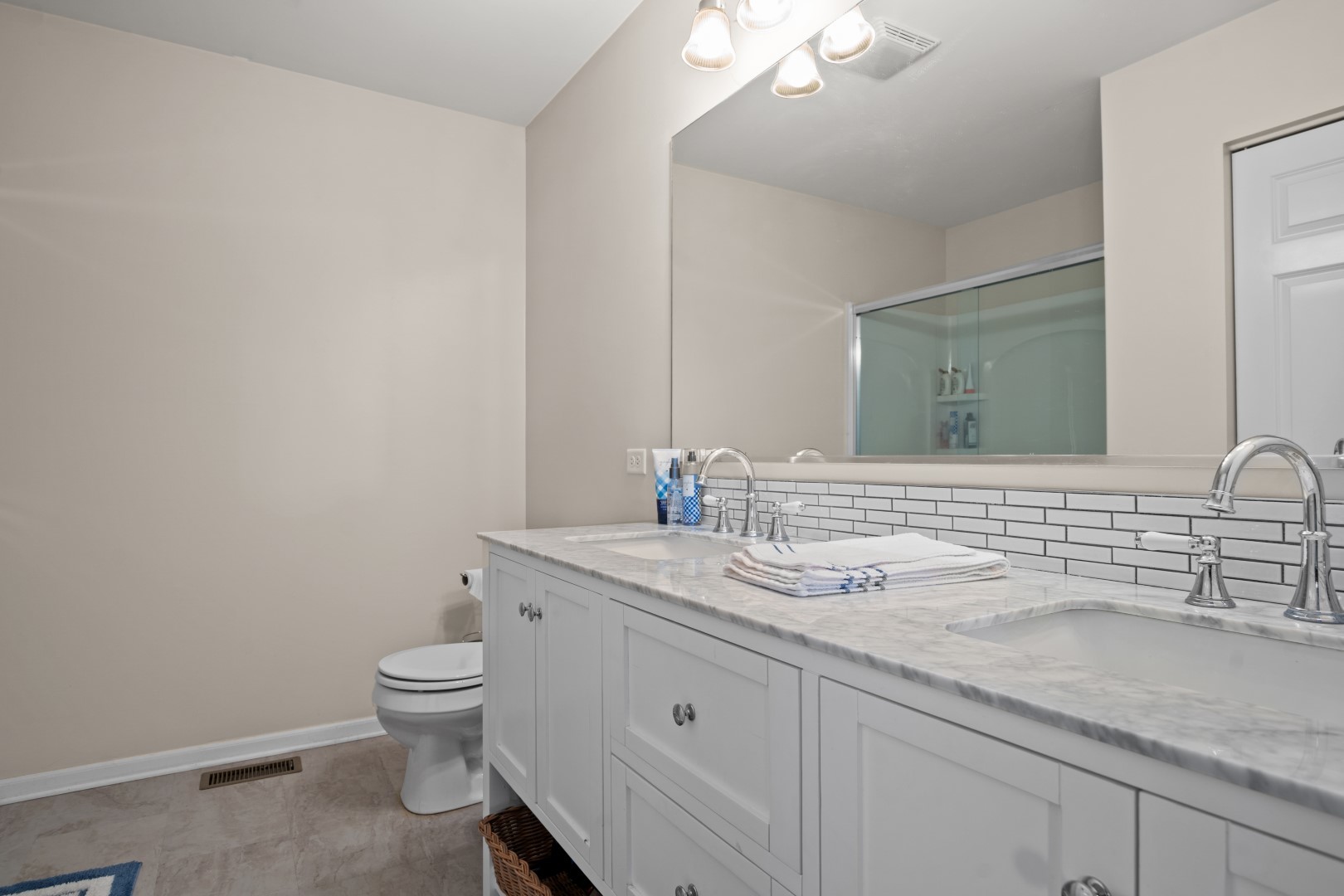 2919 Church Road Aurora, IL 60502 - Photo 19 of 28 a bathroom with a granite countertop toilet sink mirror and vanity
