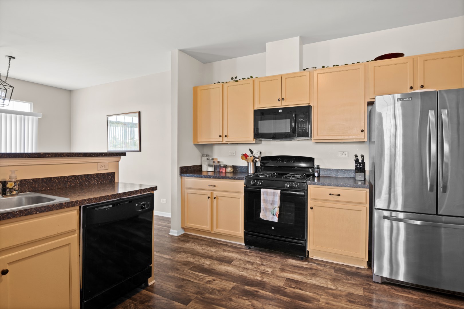 2919 Church Road Aurora, IL 60502 - Photo 10 of 28 a kitchen with a stove a sink and a refrigerator