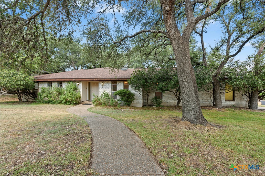 7706 West Rim Drive Austin, TX 78731 - Photo 1 of 1 a front view of a house with a yard