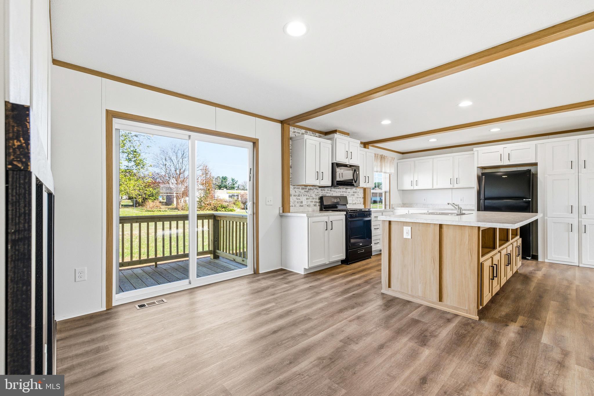 343 Park Road Stanley, VA 22851 - Photo 16 of 48 a kitchen with stainless steel appliances granite countertop a refrigerator oven a sink dishwasher and white cabinets with wooden floor