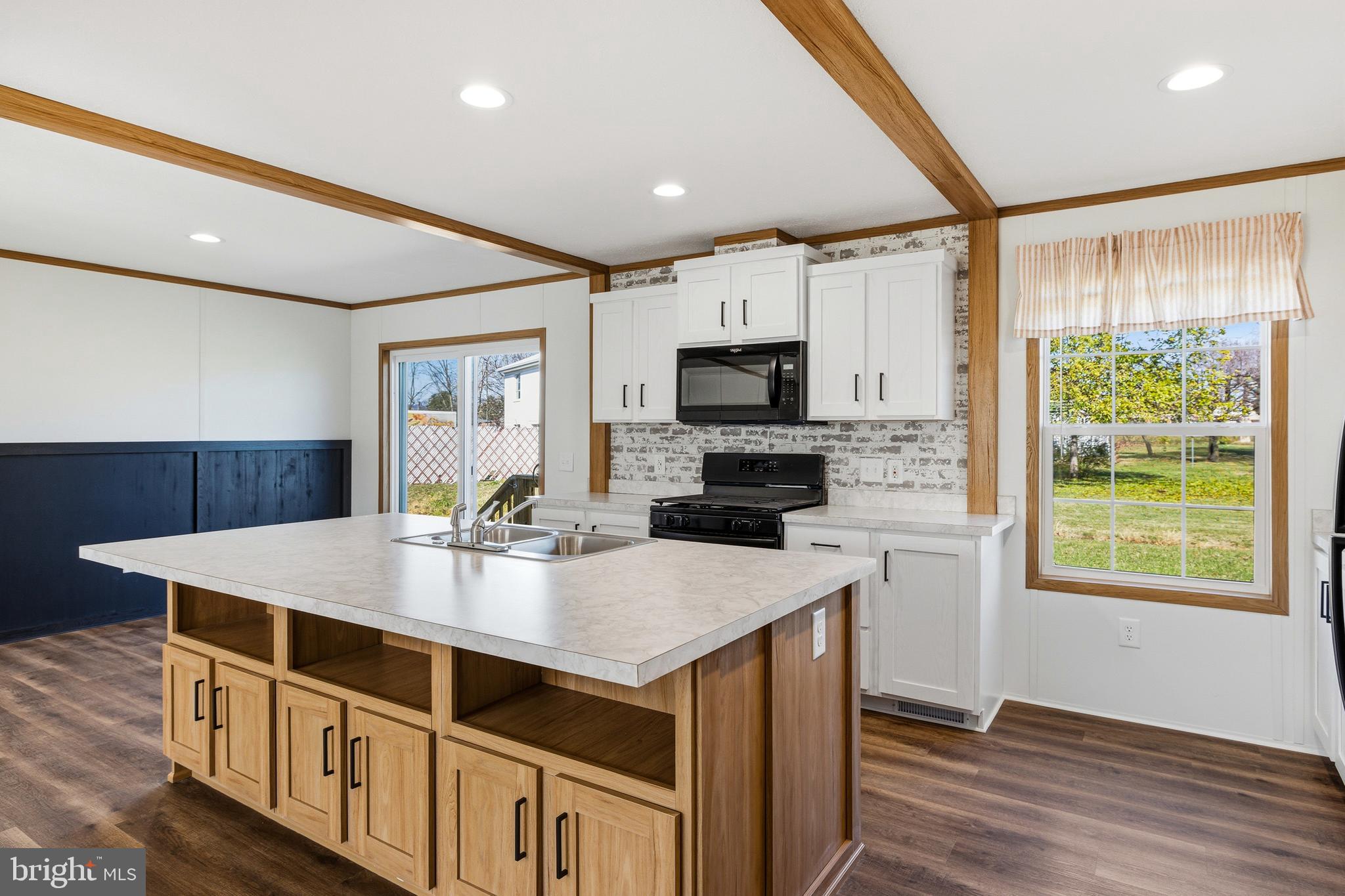 343 Park Road Stanley, VA 22851 - Photo 7 of 48 a kitchen that has a lot of cabinets in it and wooden floor