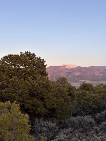 a view of a house with a mountain in the background