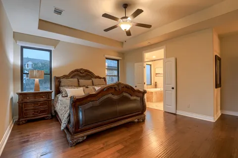 a bedroom with a bed and a chandelier