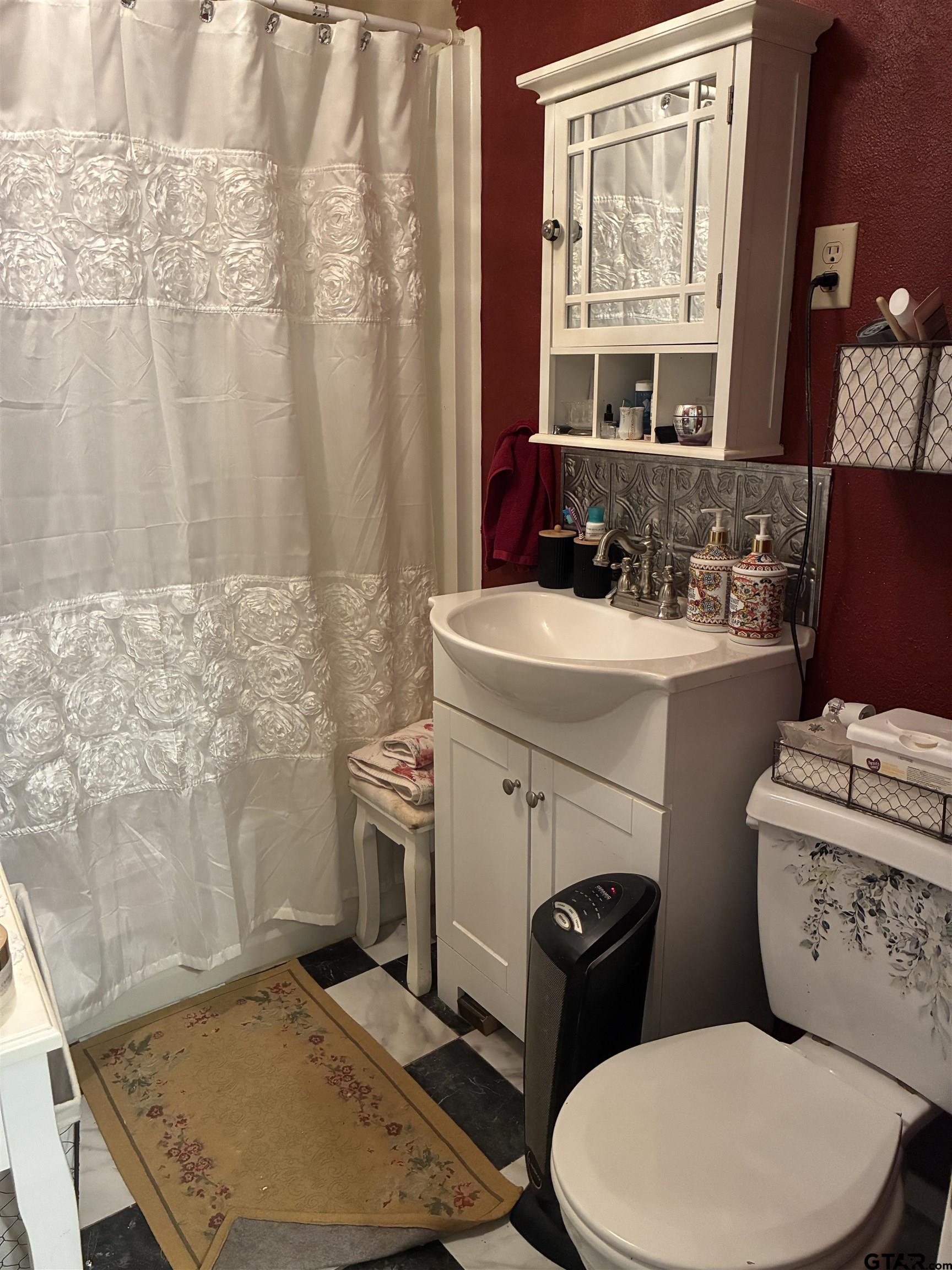 327 Fairview Street Rusk, TX 75785 - Photo 15 of 18 a bathroom with a toilet a sink and a mirror