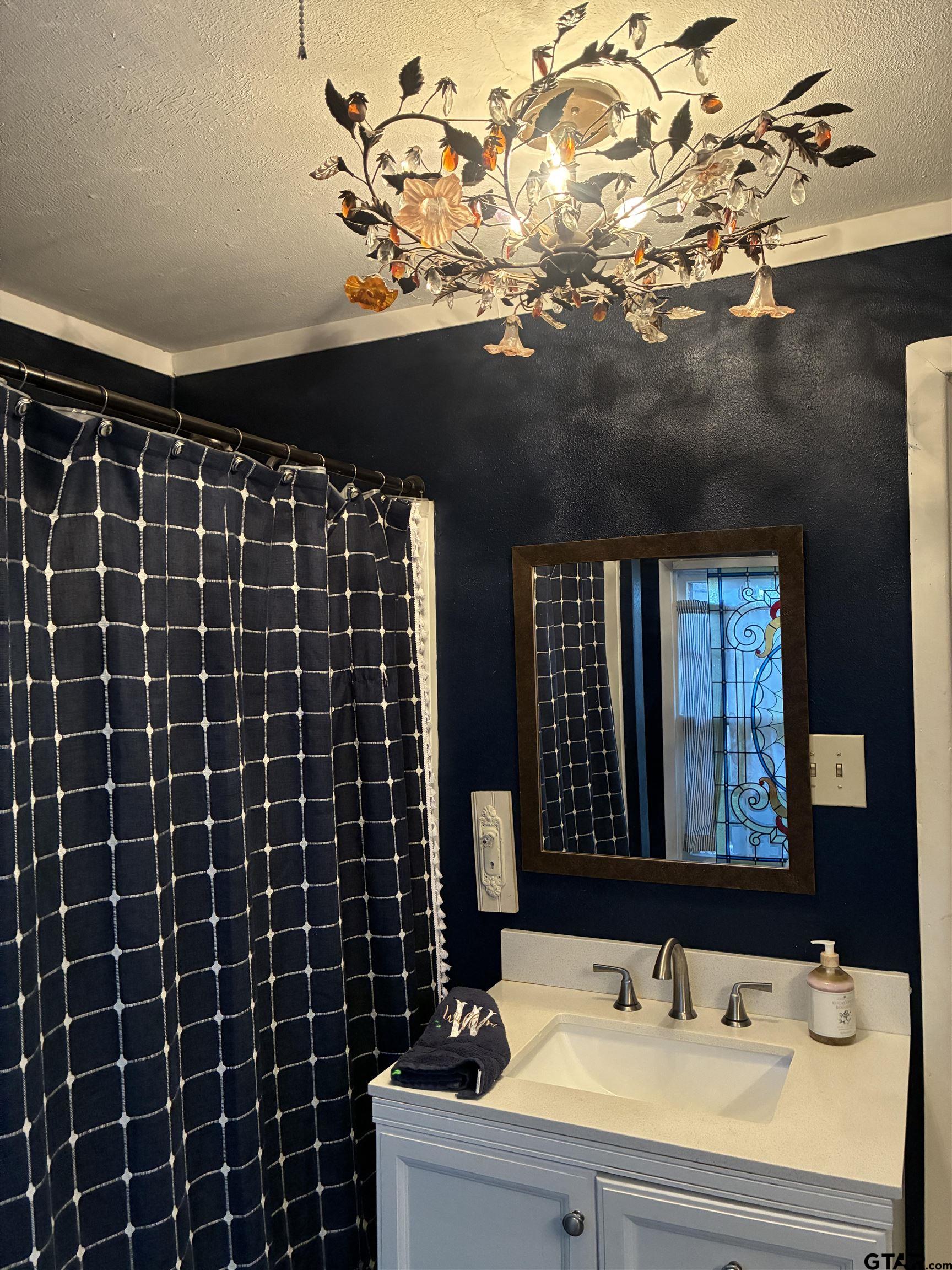 327 Fairview Street Rusk, TX 75785 - Photo 5 of 18 a bathroom with a sink vanity and a mirror