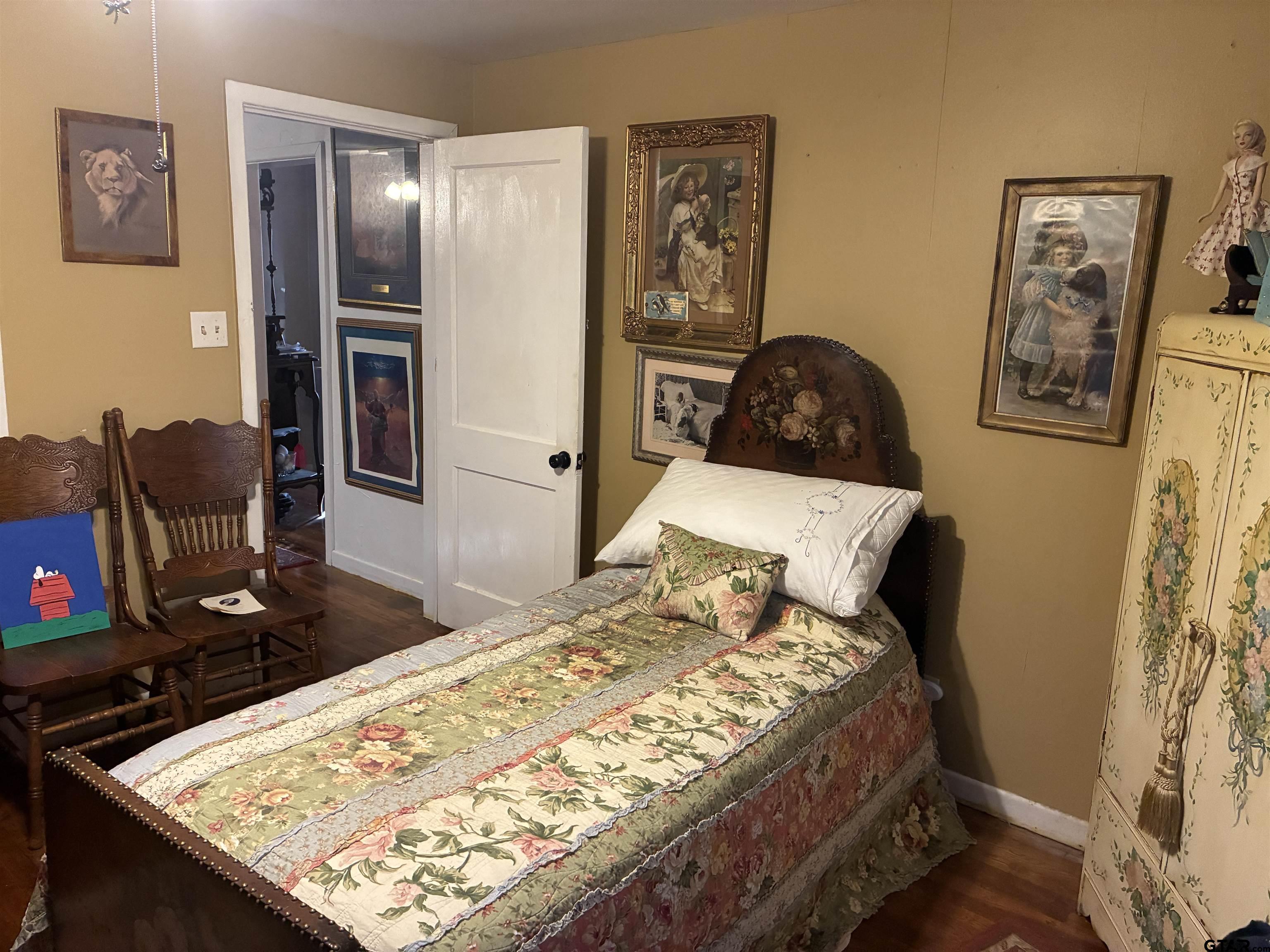 327 Fairview Street Rusk, TX 75785 - Photo 7 of 18 a bed sitting in a bedroom next to a window with chair