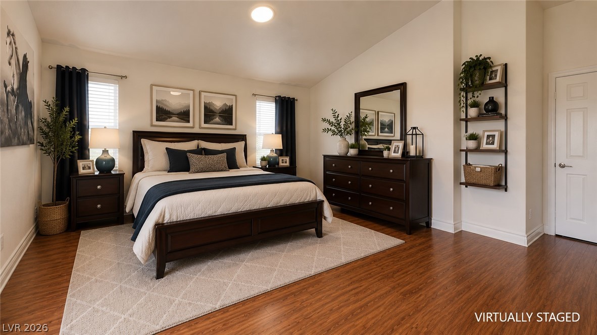 87 Tall Ruff Drive Las Vegas, NV 89148 - Photo 59 of 71 Natural light illuminates this spacious sleeping sanctuary with rich wood flooring.