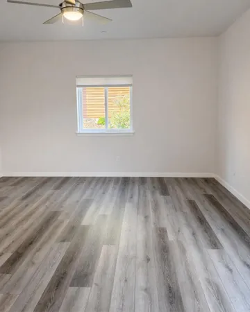 a view of an empty room and wooden floor