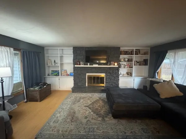 a living room with furniture a flat screen tv and a fireplace