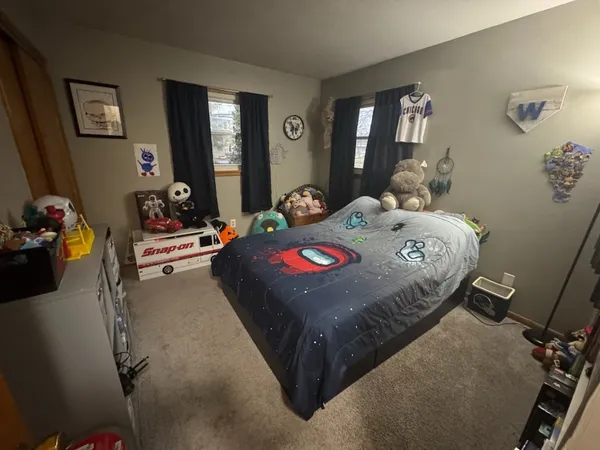 a bedroom with a bed and dresser