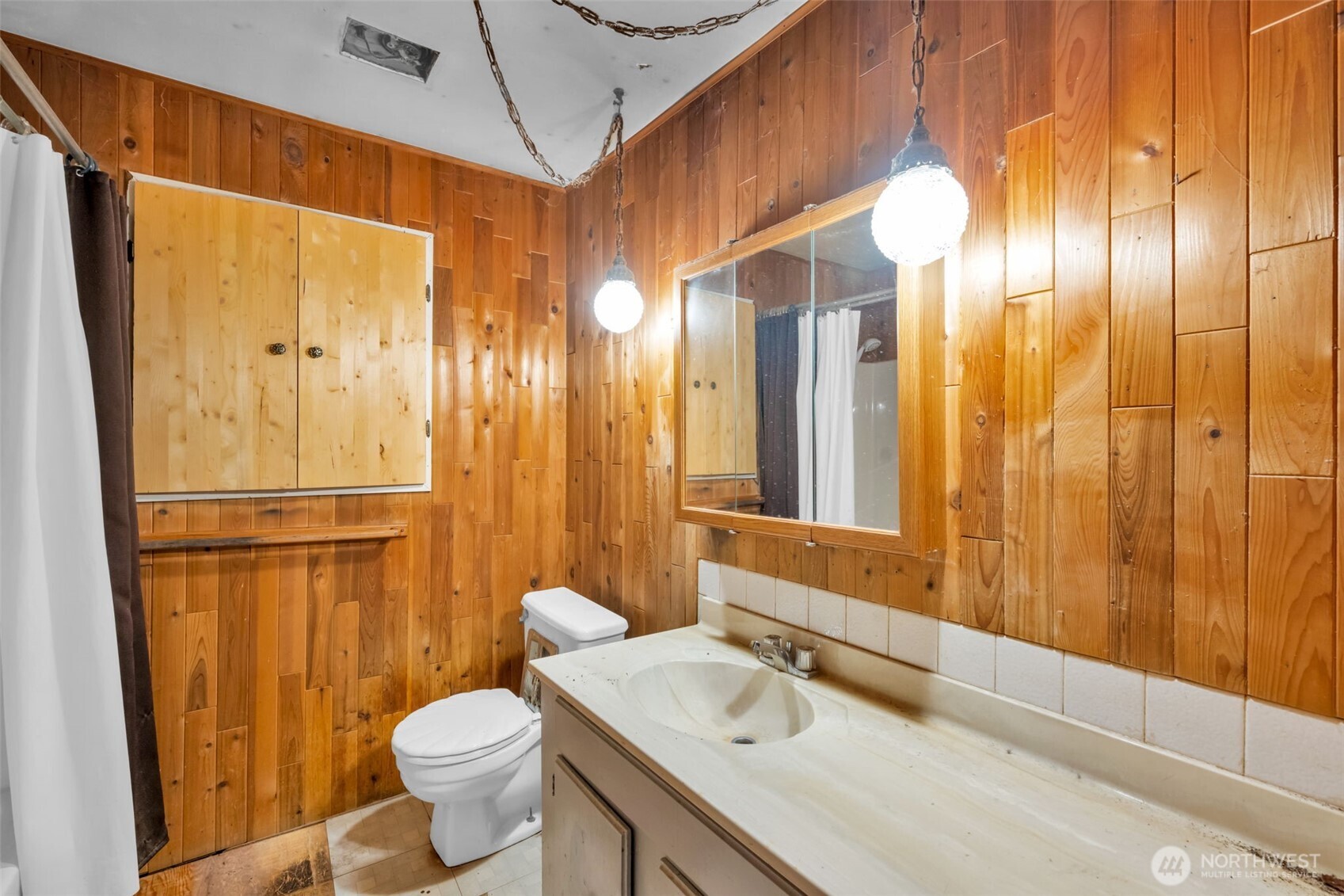 6926 East Cady Road Everett, WA 98203 - Photo 16 of 19 a bathroom with a granite countertop sink and a mirror