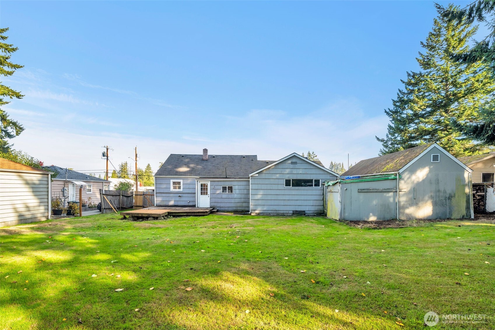 6926 East Cady Road Everett, WA 98203 - Photo 4 of 19 a view of a house with a big yard and large trees
