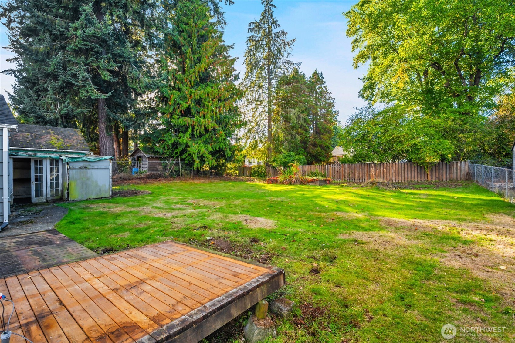 6926 East Cady Road Everett, WA 98203 - Photo 6 of 19 a view of a backyard with table and chairs and wooden fence