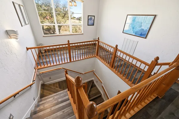 a view of staircase with furniture and a window