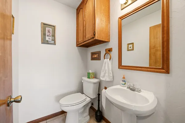 a bathroom with a toilet sink and mirror