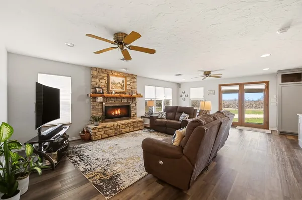 a living room with furniture a flat screen tv and a fireplace