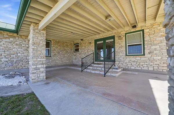 a view of an house with backyard space and balcony