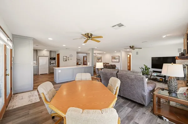 a living room with furniture a dining table and a piano table