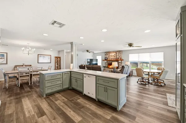 a kitchen with sink cabinets and wooden floor