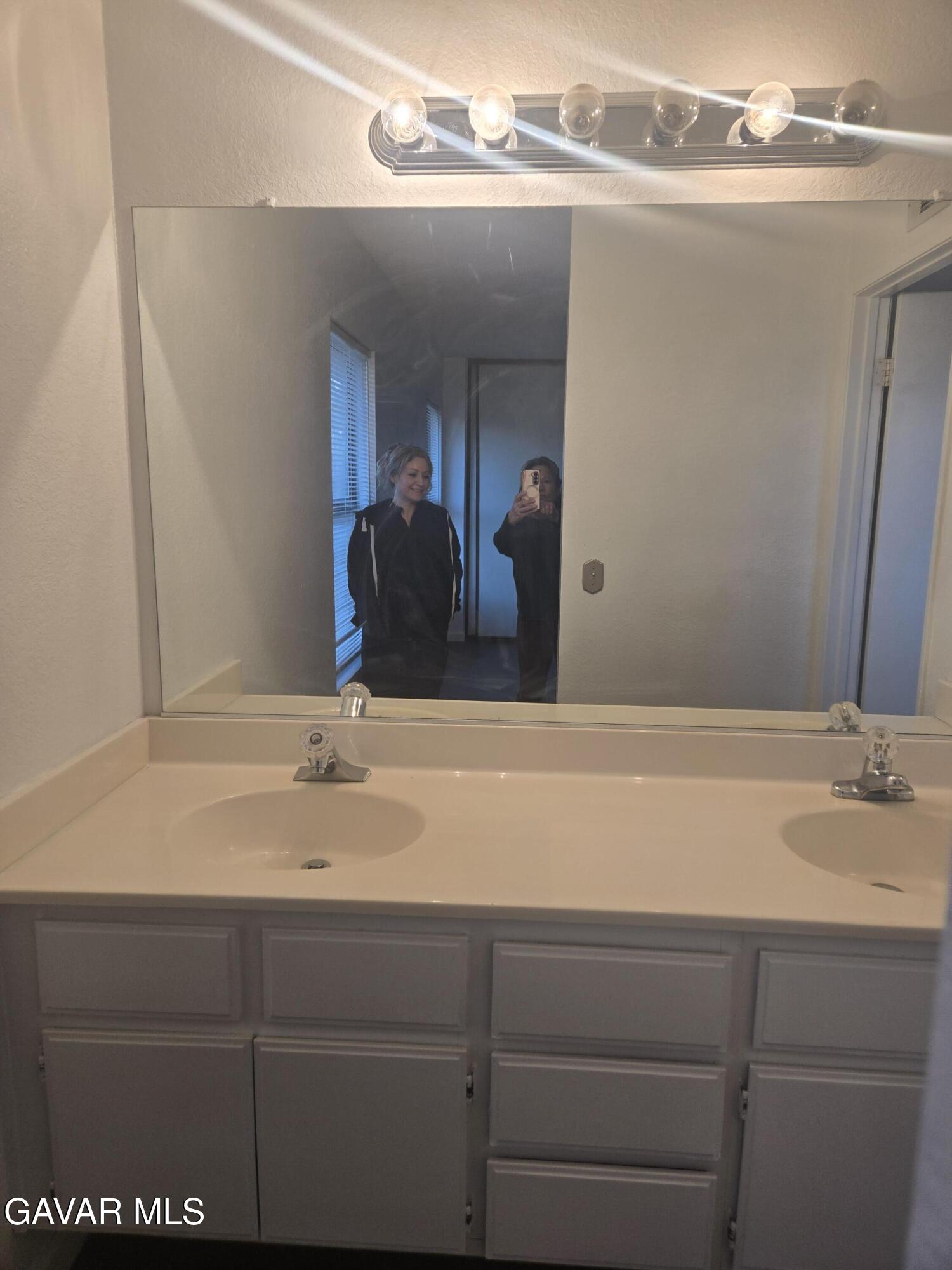 37414 Drexel Street Palmdale, CA 93550 - Photo 4 of 7 a bathroom with a sink and a mirror