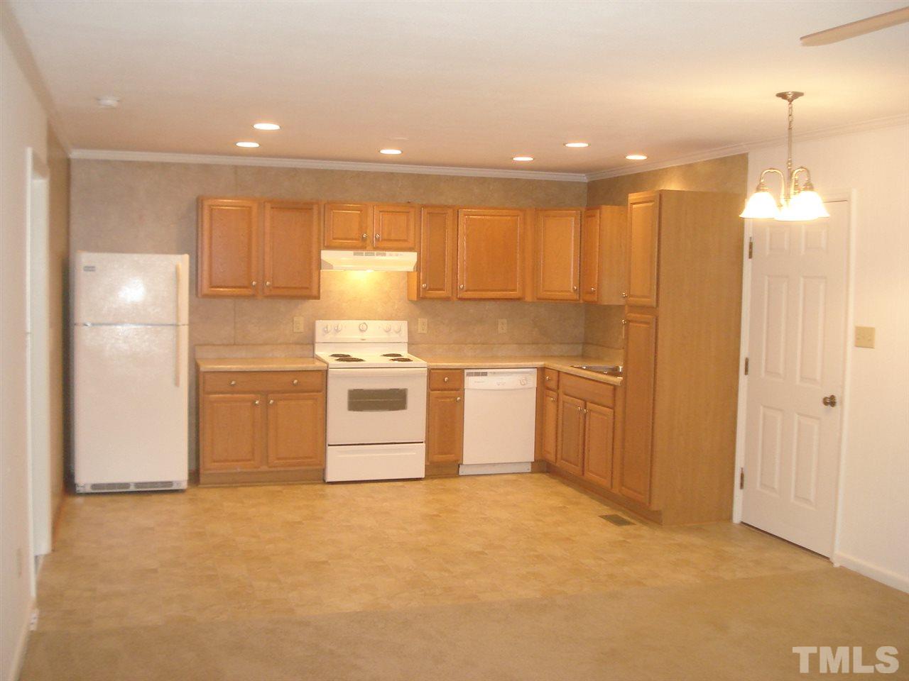 1221 Bill Poole Road Rougemont, NC 27572 - Photo 8 of 17 a view of a kitchen with a sink and dishwasher a refrigerator with white cabinets