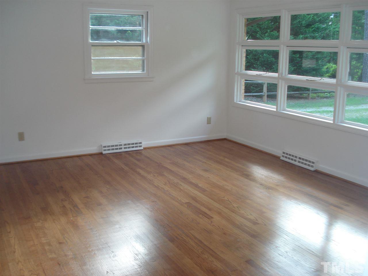 1221 Bill Poole Road Rougemont, NC 27572 - Photo 10 of 17 an empty room with wooden floor and windows