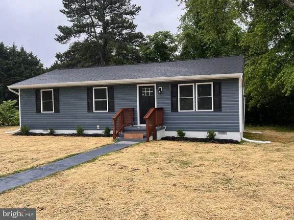 a backyard of a house with yard and seating space