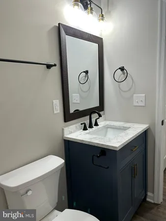 a bathroom with a toilet sink and mirror