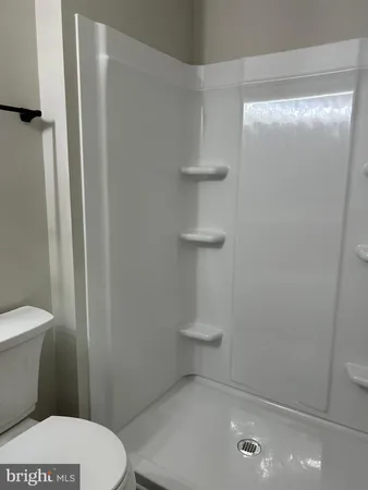 a white toilet sitting next to a bathroom sink