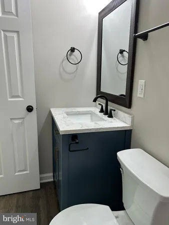 a bathroom with a sink a toilet a mirror and shower curtain