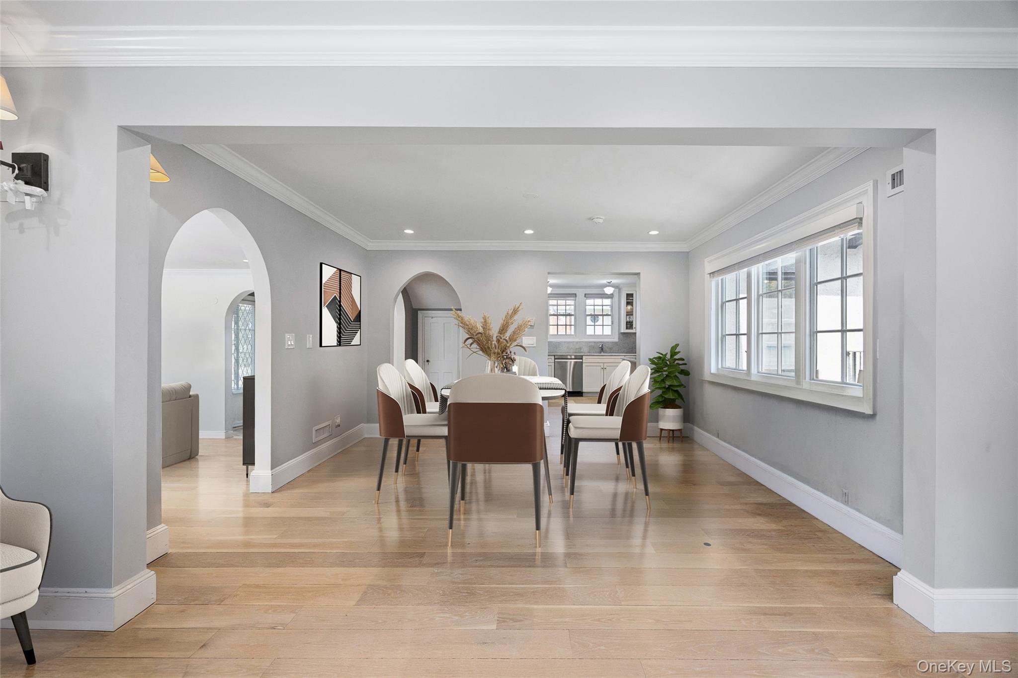 216 Beverly Road Queens, NY 11363 - Photo 6 of 50 a dining room with furniture a potted plant and wooden floor