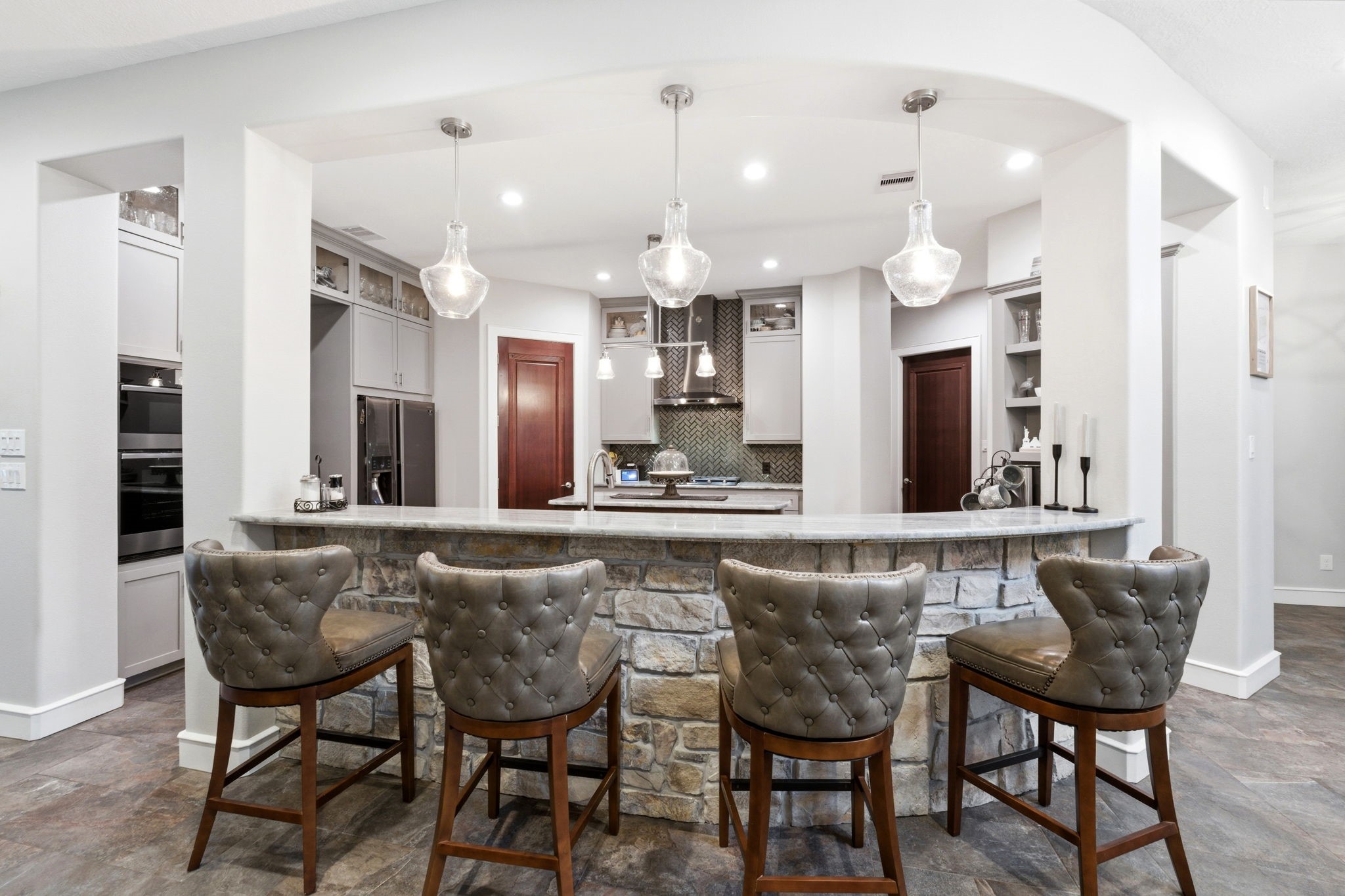 280 Sundog Road Huntsville, TX 77340 - Photo 14 of 50 Breakfast bar with seating provides a welcoming place for casual dining or conversation while cooking, connecting the kitchen to the main living spaces.