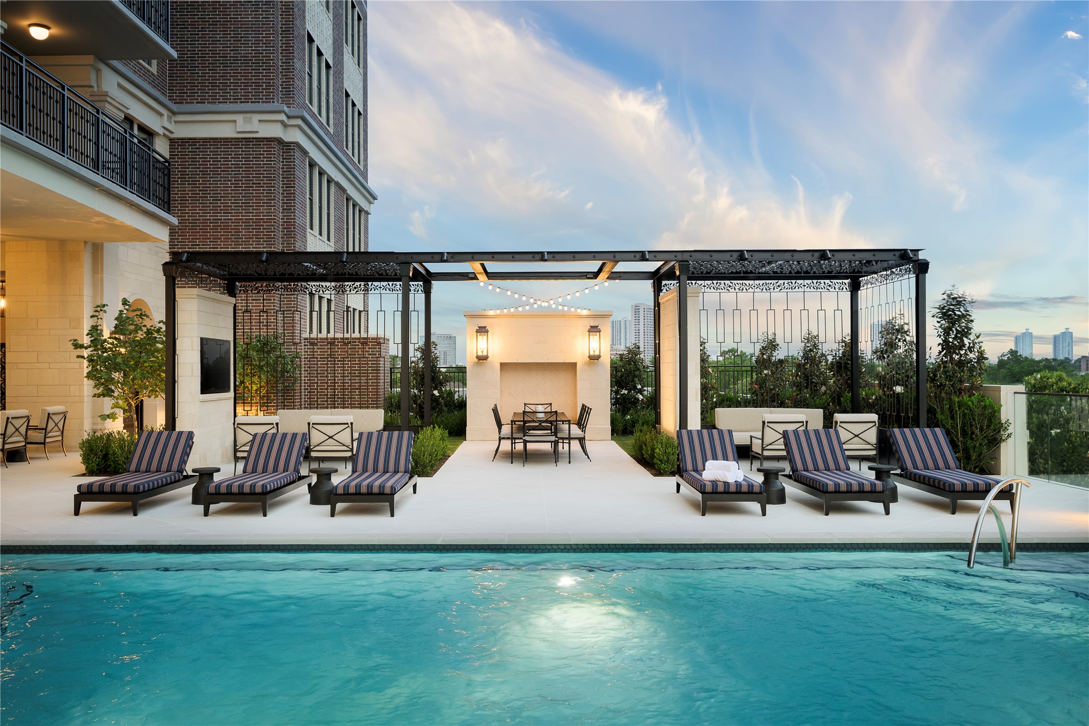 1717 Bissonnet Street, Unit 1106 Houston, TX 77005 - Photo 47 of 50 Four cabanas with televisions and a limestone fireplace.