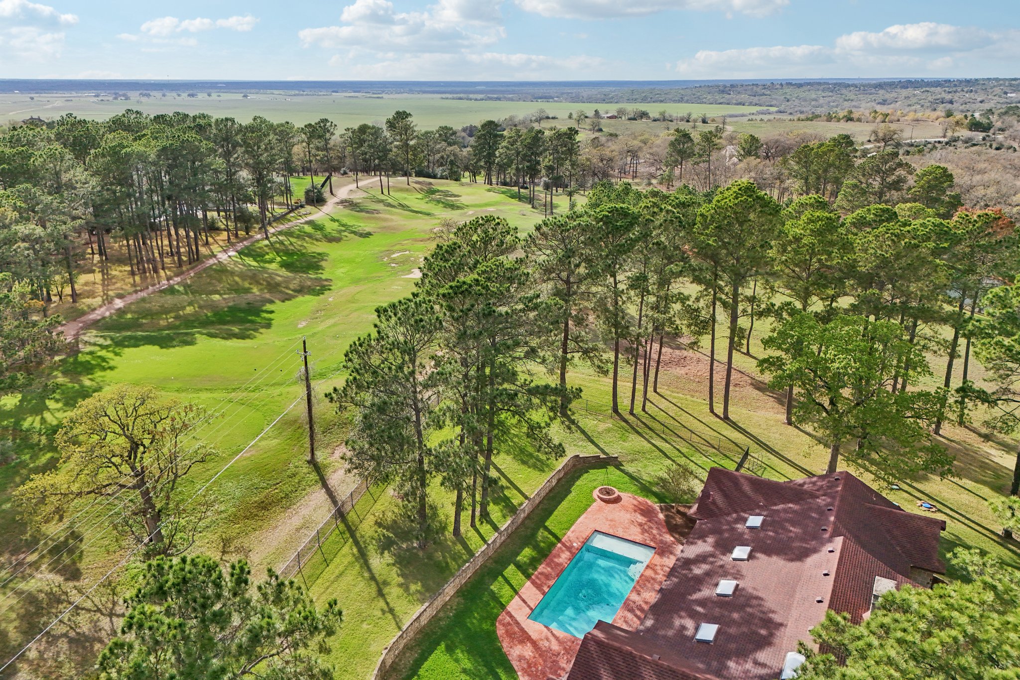 546 McAllister Road Bastrop, TX 78602 - Photo 3 of 40 Bird's eye view of a tree filled landscape and a golf club