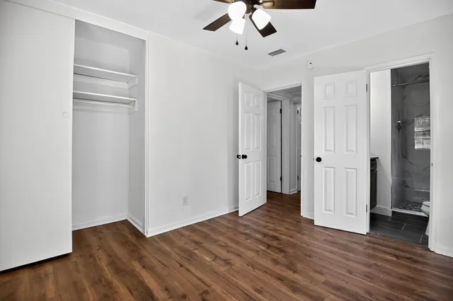 a view of an empty room with wooden floor