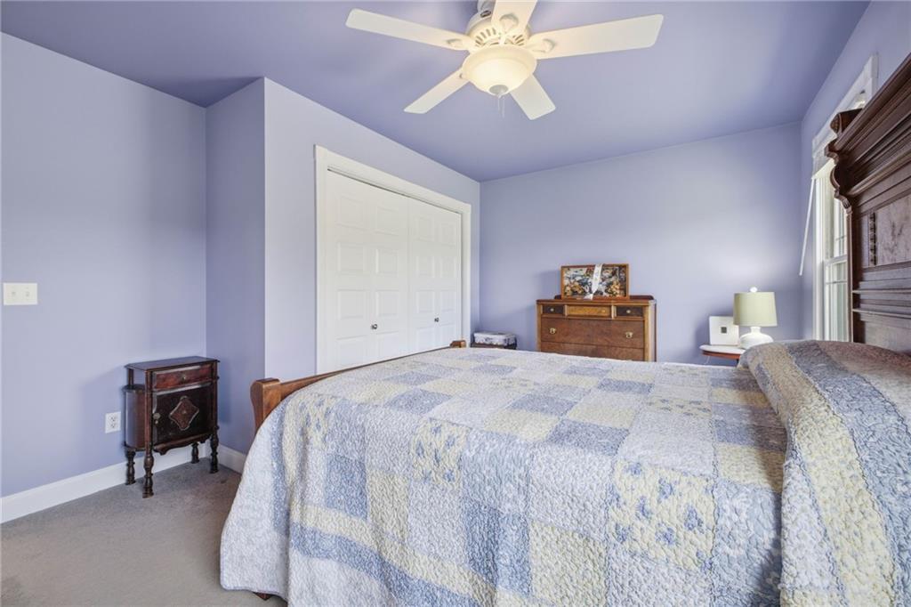 6729 Big Texas Valley Road Northwest Rome, GA 30165 - Photo 65 of 95 a bedroom with a bed and a chandelier