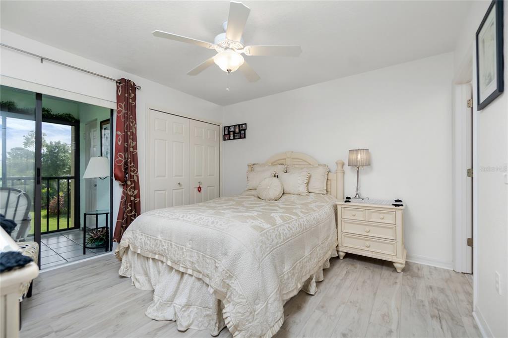 4260 Placida Road, Unit 9B Englewood, FL 34224 - Photo 11 of 38 a bedroom with a bed and a chandelier