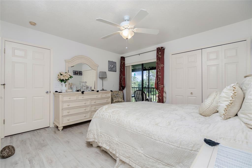 4260 Placida Road, Unit 9B Englewood, FL 34224 - Photo 12 of 38 a bedroom with a large bed and a chandelier fan