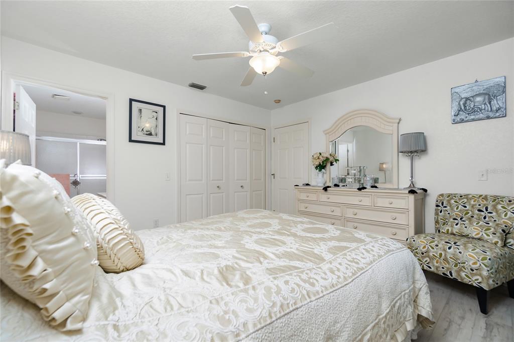 4260 Placida Road, Unit 9B Englewood, FL 34224 - Photo 13 of 38 a bedroom with a large bed and a chandelier