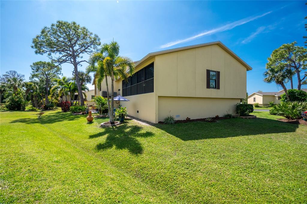 4260 Placida Road, Unit 9B Englewood, FL 34224 - Photo 29 of 38 a view of a backyard with plants and a garden