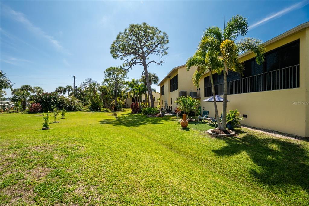 4260 Placida Road, Unit 9B Englewood, FL 34224 - Photo 30 of 38 a backyard of a house with lots of green space