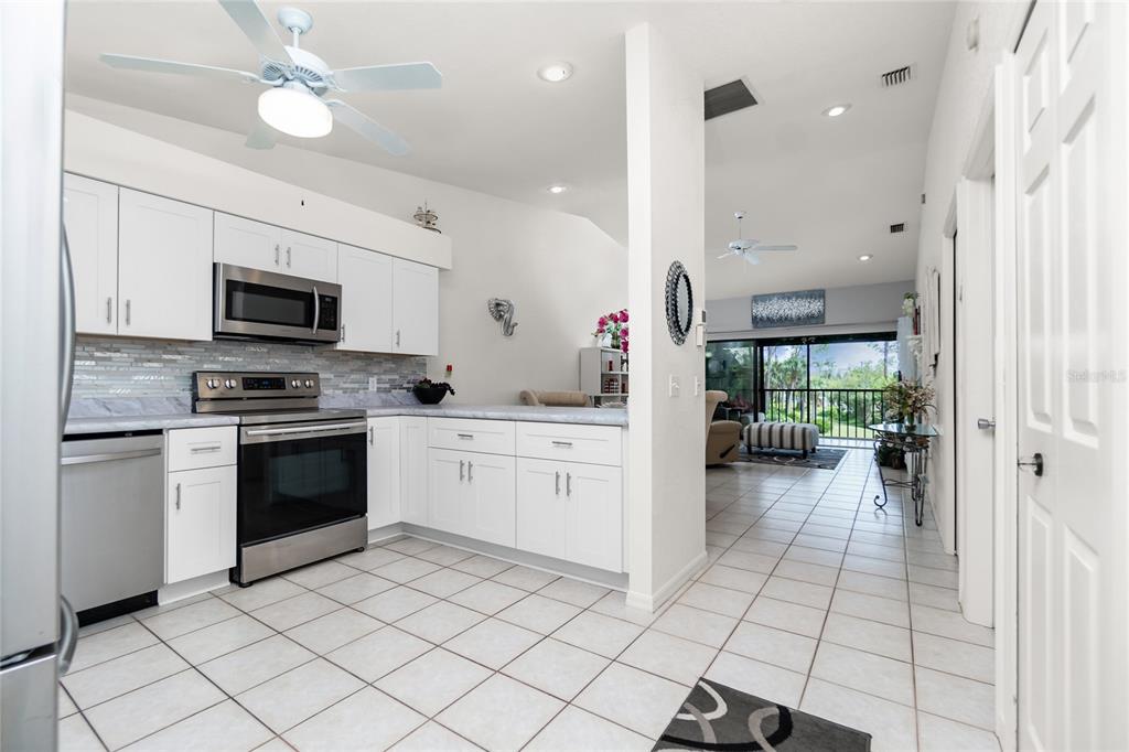 4260 Placida Road, Unit 9B Englewood, FL 34224 - Photo 3 of 38 a kitchen with a stove a sink and a microwave