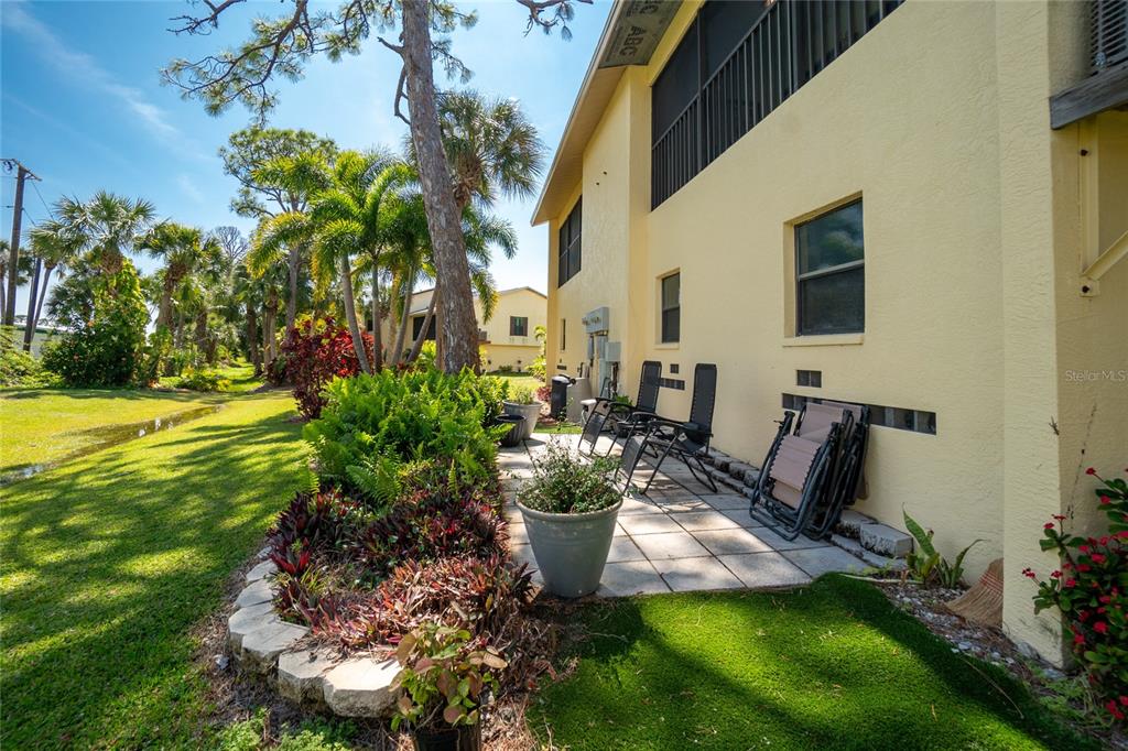 4260 Placida Road, Unit 9B Englewood, FL 34224 - Photo 31 of 38 a view of a backyard with plants and a patio