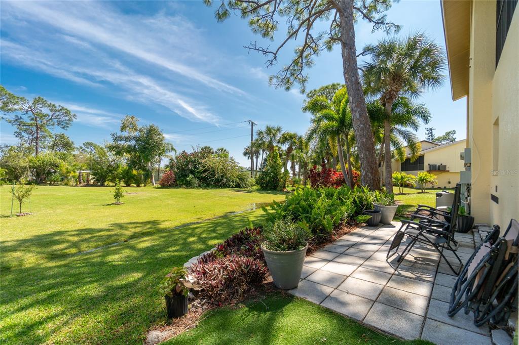 4260 Placida Road, Unit 9B Englewood, FL 34224 - Photo 32 of 38 a view of yard with swimming pool and green space