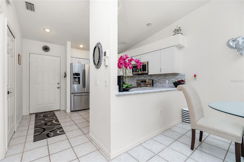 4260 Placida Road, Unit 9B Englewood, FL 34224 - Photo 6 of 38 a kitchen with stainless steel appliances a refrigerator sink and cabinets