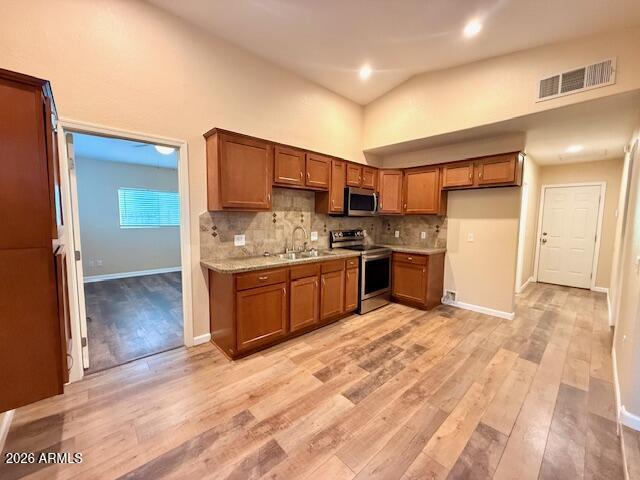324 South Ocotillo Drive Apache Junction, AZ 85120 - Photo 3 of 14 a kitchen with stainless steel appliances kitchen island granite countertop a refrigerator and a stove top oven